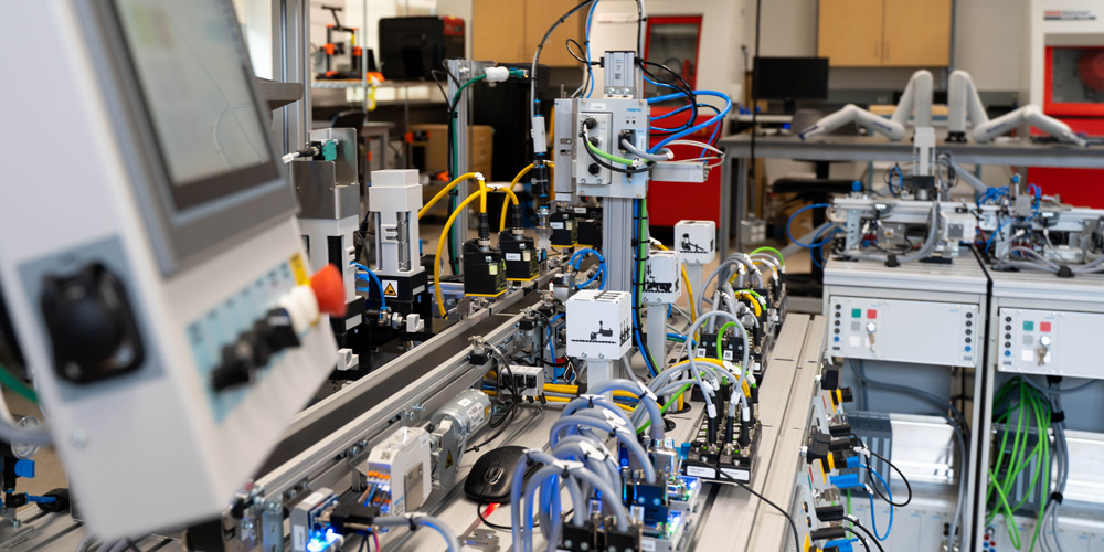 An image of industrial automation equipment with a close up of a mouse and 3D printer